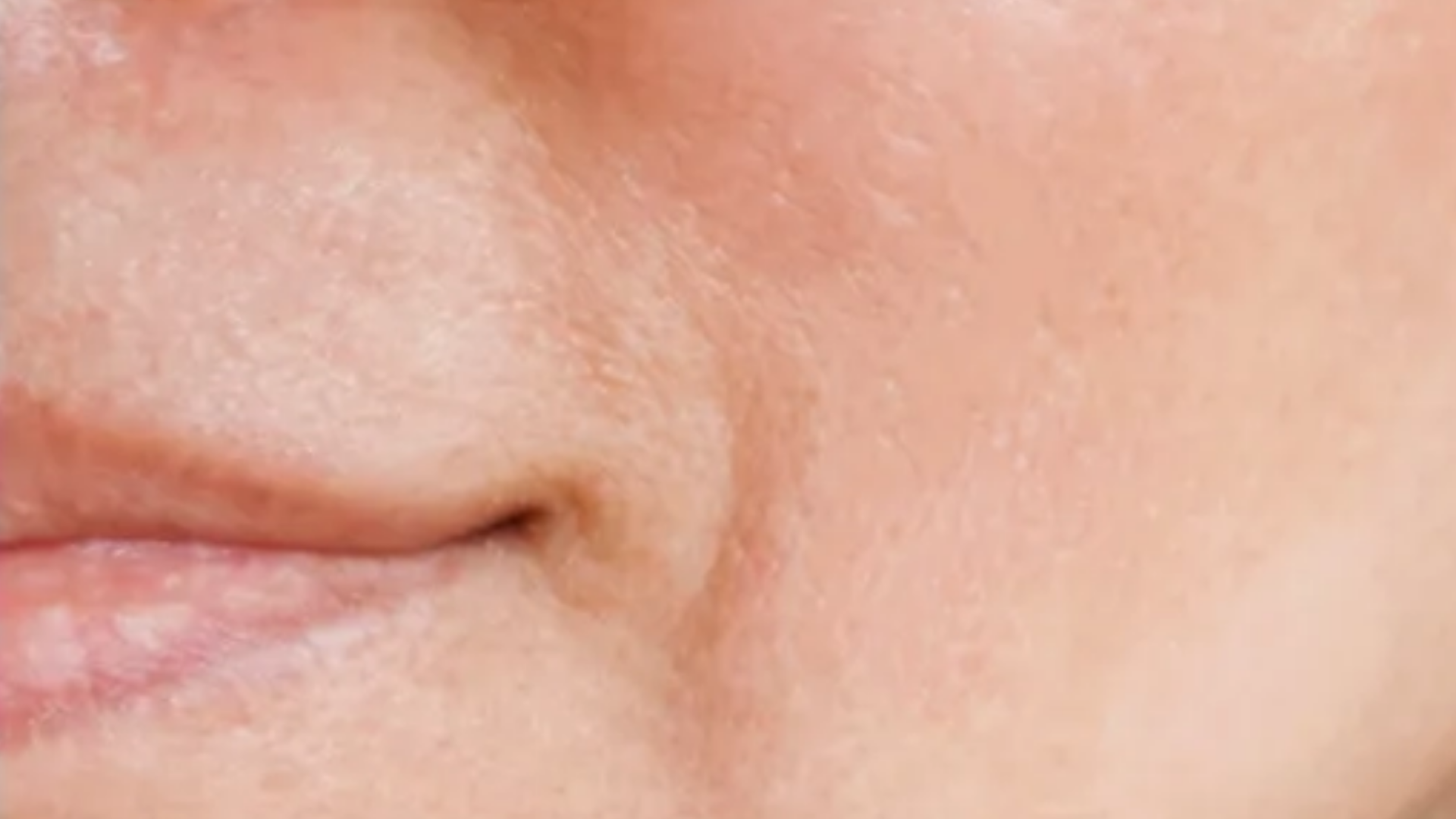 Close-up of a person's nose and lips with a blurred background