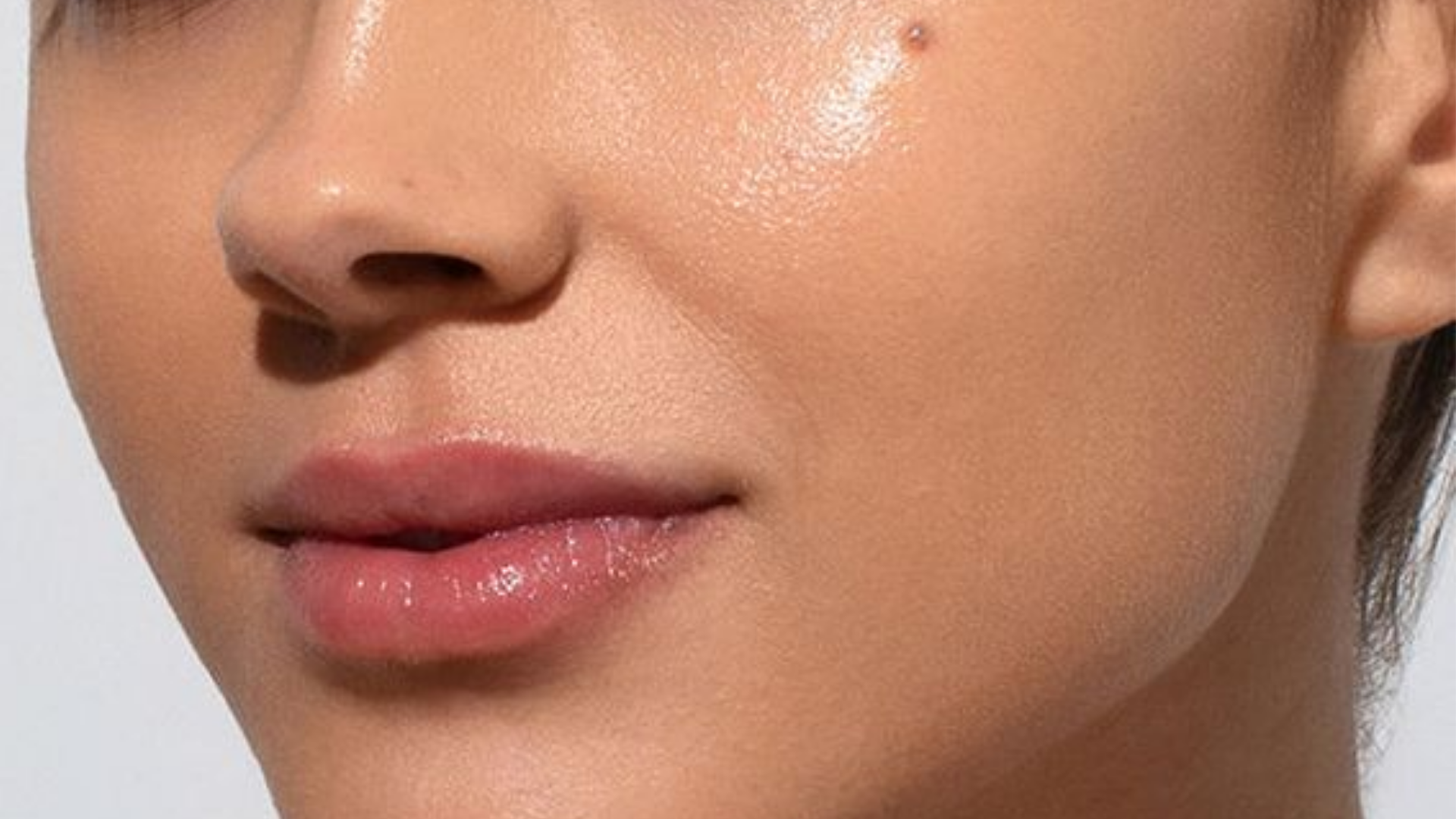 Close-up of a person's face with a focus on the lips and skin texture.