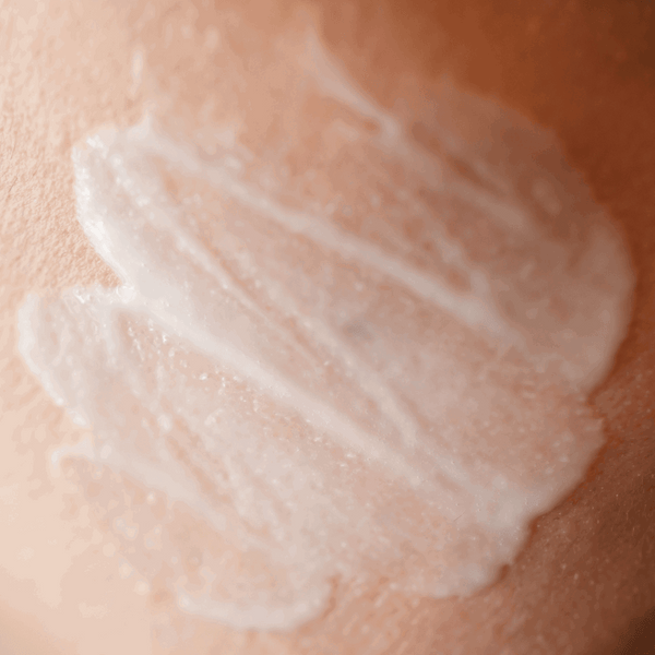 Close-up of a swatch of white cream on skin
