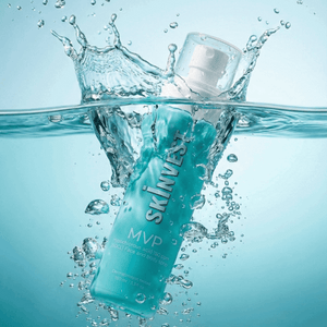 Skincare bottle labeled 'SKINVEST MVP' splashing in water with a blue gradient background