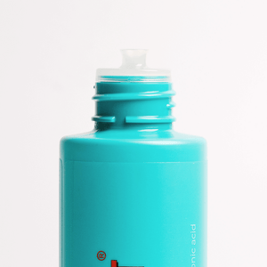 Turquoise bottle with a white cap on a light gray background