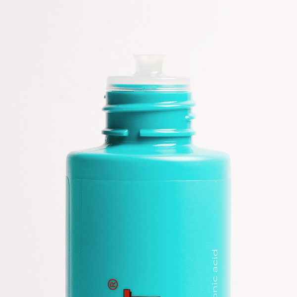 Turquoise bottle with a white cap on a light gray background