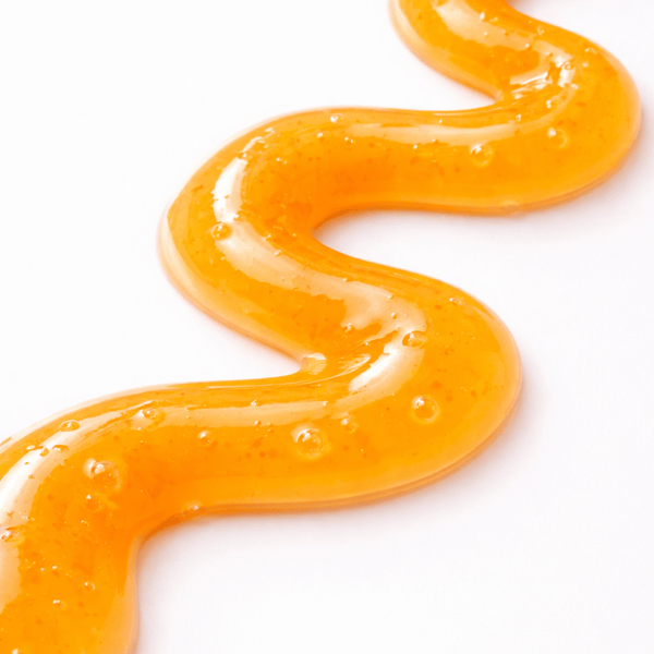 Orange slime in a wavy pattern on a white background