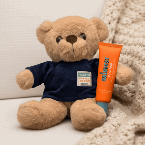 Teddy bear holding a Salveve tube on a soft surface