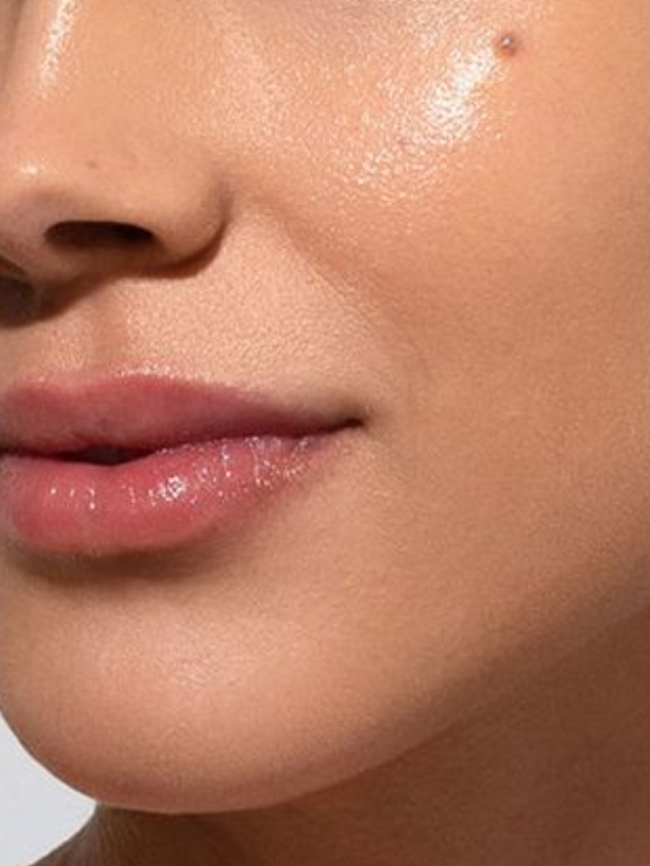 Close-up of a person's lips with a neutral background